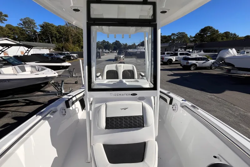 Slide: The Image of 2026 Tidewater 210 CC Adventure boat interior at a dealership, showcasing seating and console. - 9