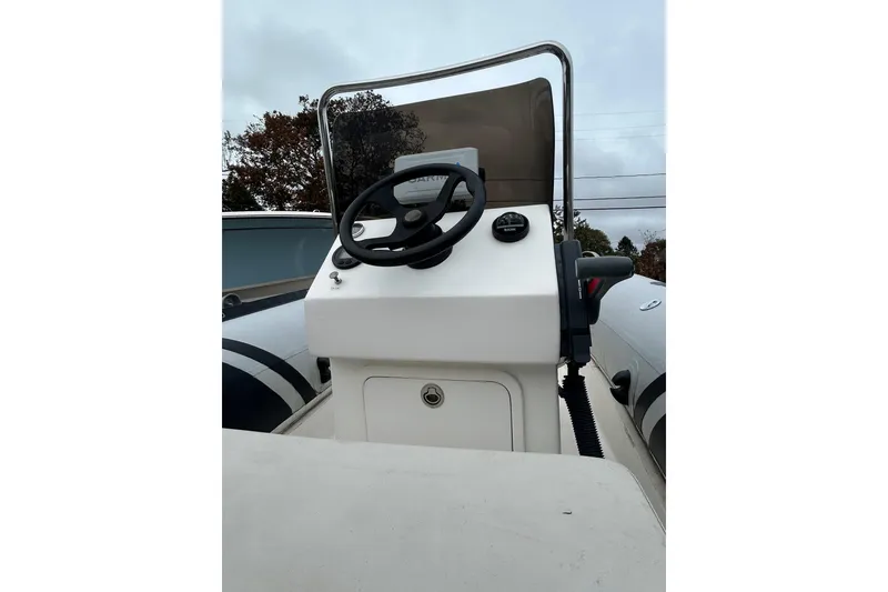 Slide: The Image of 2018 North Atlantic Inflatables RIB420 with Yamaha outboard motor, parked on gravel. - 2