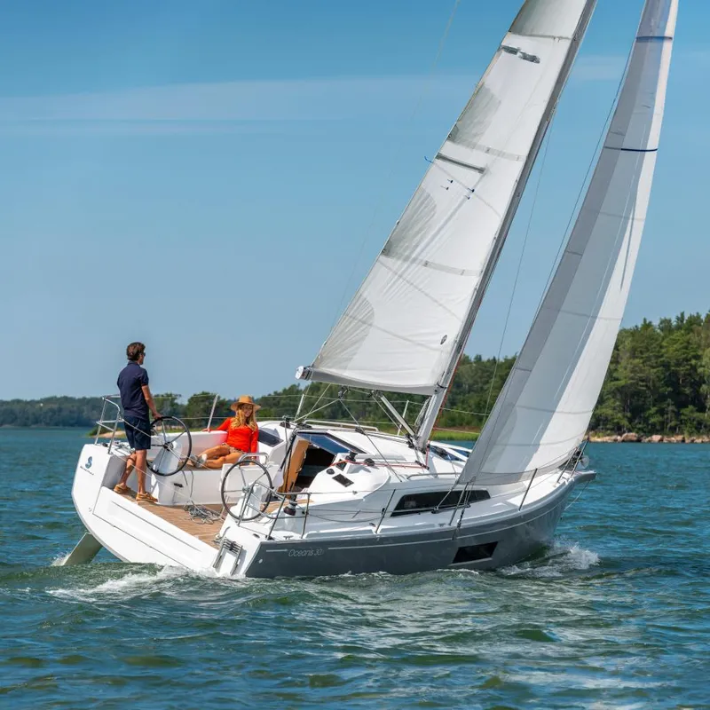 The Image of 2025 Beneteau Oceanis 30.1 sailing on a sunny day, two people onboard. - 0