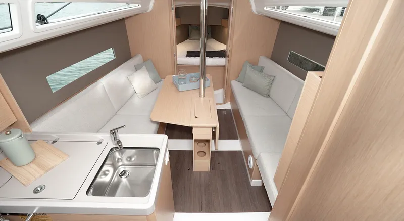 Slide: The Image of 2025 Beneteau Oceanis 30.1 interior with modern kitchen and cozy seating area. - 14