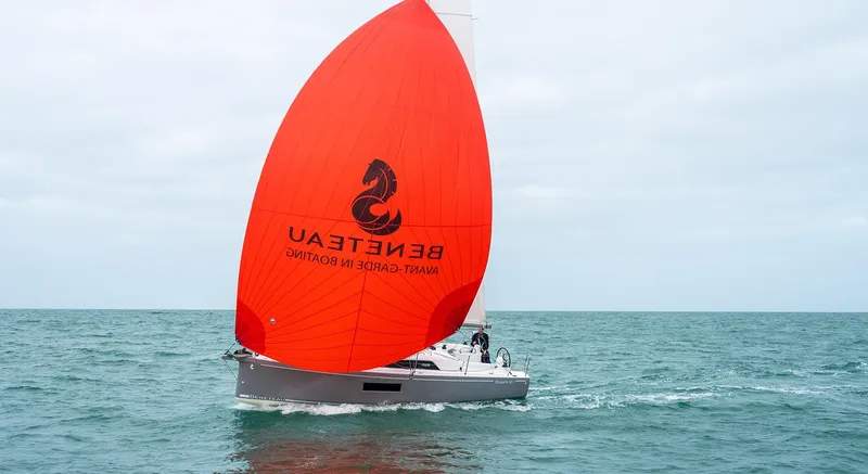 Slide: The Image of 2025 Beneteau Oceanis 30.1 sailing with vibrant red spinnaker on open sea. - 7