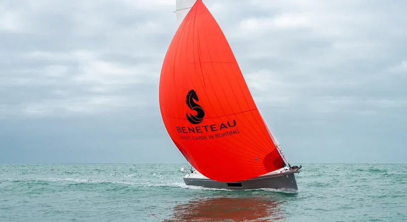 Slide: The Image of 2025 Beneteau Oceanis 30.1 sailing with vibrant red sail on open water. - 9