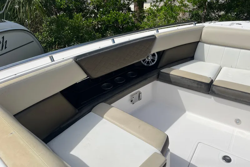 Slide: The Image of 2014 Regal 3200 Bowrider interior with cushioned seating and cup holders. - 11