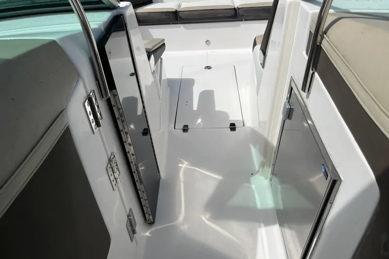 Slide: The Image of 2014 Regal 3200 Bowrider interior with seating and storage compartments. - 14