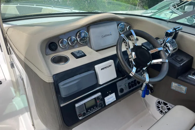 Slide: The Image of Dashboard of a 2014 Regal 3200 Bowrider with Garmin navigation and Mercury controls. - 15