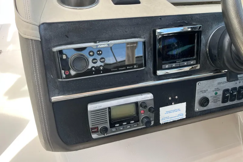 Slide: The Image of 2014 Regal 3200 Bowrider dashboard with audio and navigation controls. - 17