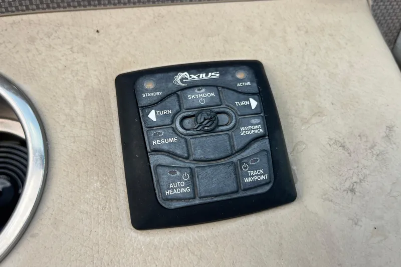 Slide: The Image of Control panel of a 2014 Regal 3200 Bowrider boat with Axius system. - 18
