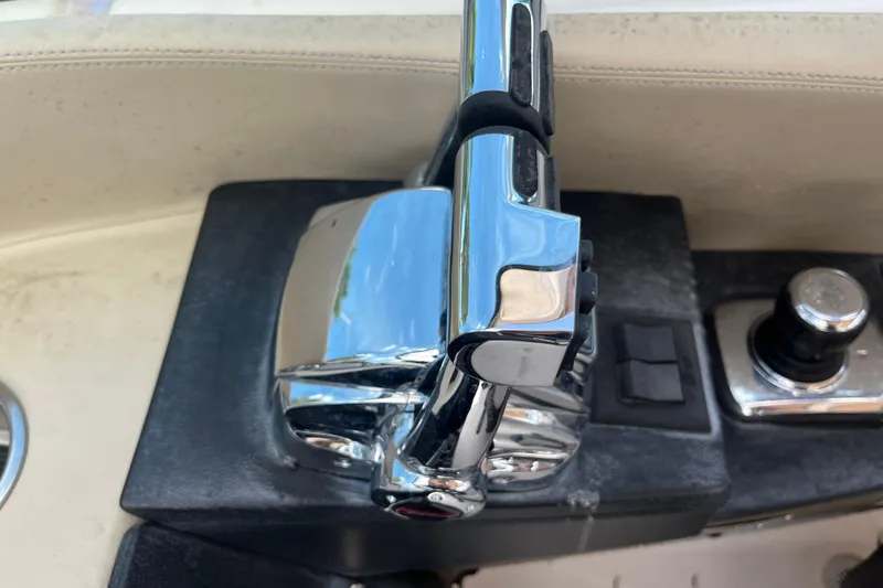 Slide: The Image of Chrome throttle controls on a 2014 Regal 3200 Bowrider boat dashboard. - 19