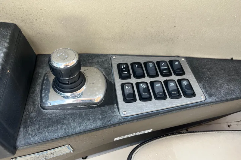 Slide: The Image of Control panel of a 2014 Regal 3200 Bowrider boat with joystick and switches. - 20