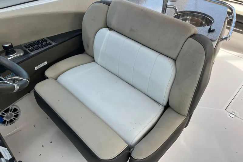 Slide: The Image of 2014 Regal 3200 Bowrider interior with dual-tone seating and control panel. - 21