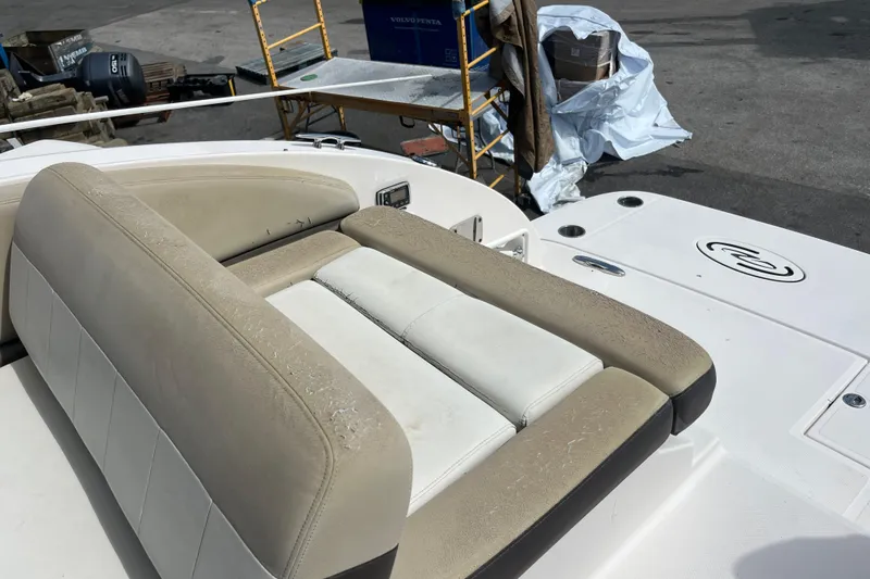 Slide: The Image of 2014 Regal 3200 Bowrider boat with worn beige seating and deck details. - 25