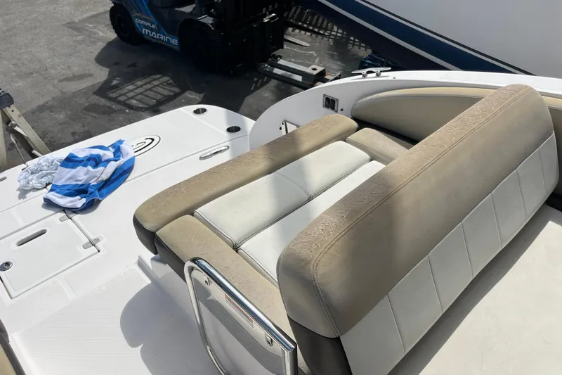 Slide: The Image of 2014 Regal 3200 Bowrider boat interior with seating and a striped towel. - 26