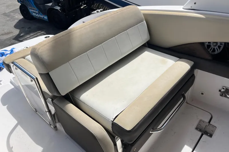 Slide: The Image of 2014 Regal 3200 Bowrider boat seat with beige and white upholstery. - 27