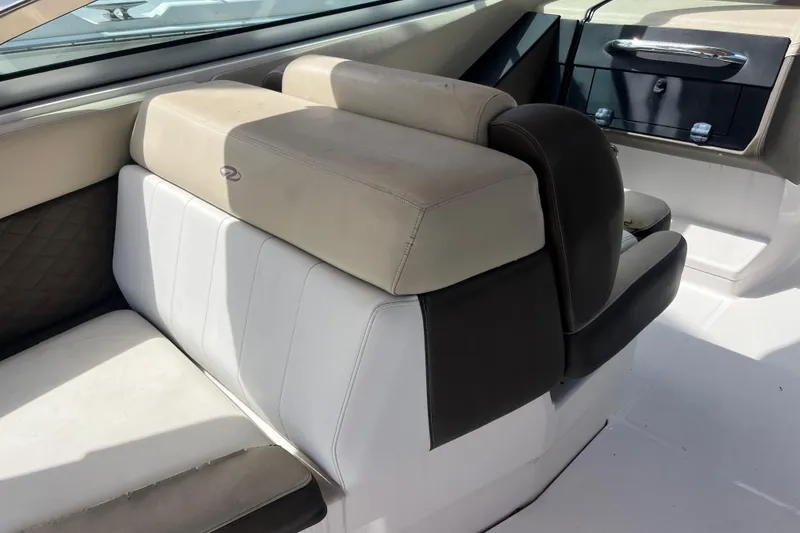 Slide: The Image of 2014 Regal 3200 Bowrider interior seating with beige and white upholstery. - 29