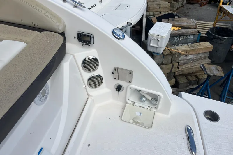 Slide: The Image of 2014 Regal 3200 Bowrider boat interior with seating and storage compartments. - 33