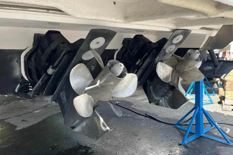 Slide: The Image of 2014 Regal 3200 Bowrider boat propellers on stands, showcasing dual outdrive system. - 39