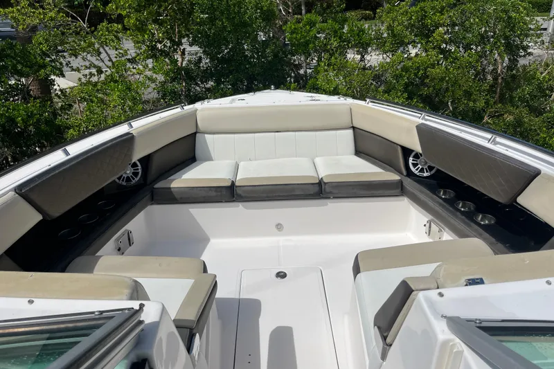 Slide: The Image of 2014 Regal 3200 Bowrider boat interior with cushioned seating and cup holders. - 7