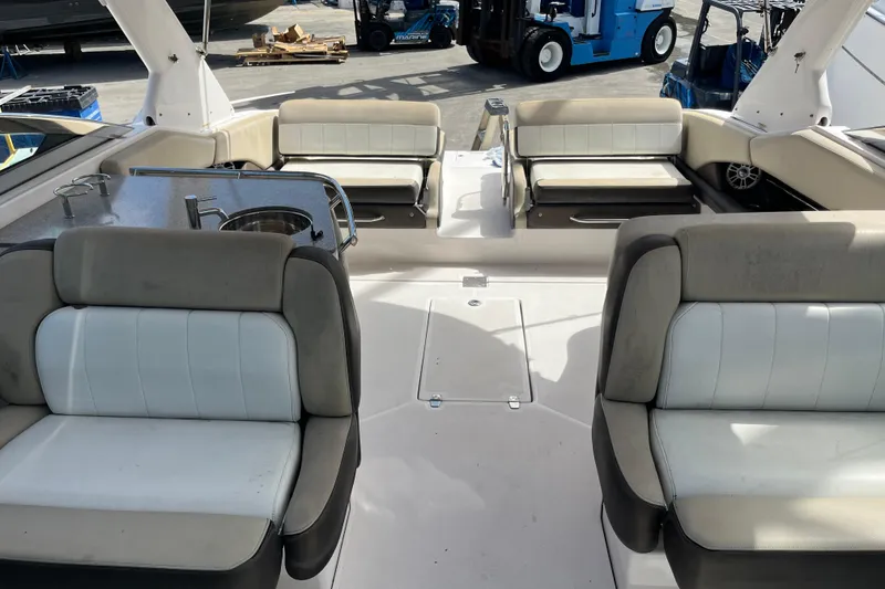 Slide: The Image of 2014 Regal 3200 Bowrider interior with seating and kitchenette, docked at marina. - 8