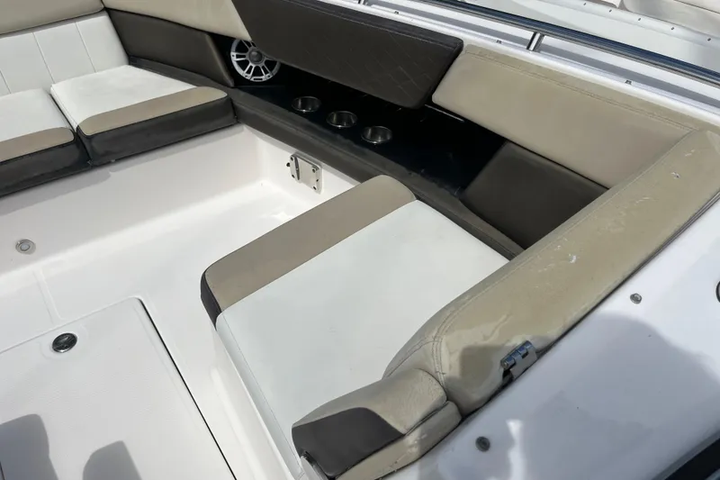 Slide: The Image of 2014 Regal 3200 Bowrider interior seating with cup holders and speaker. - 9