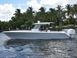 The Image of 2025 Jupiter 380 LS boat on water with palm trees in background. - 1