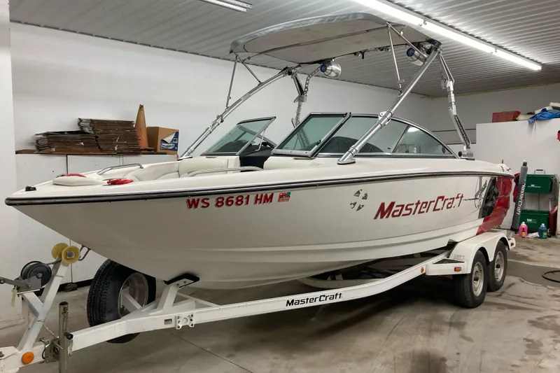 The Image of 2008 MasterCraft MariStar 215 boat on trailer in a garage setting. - 0