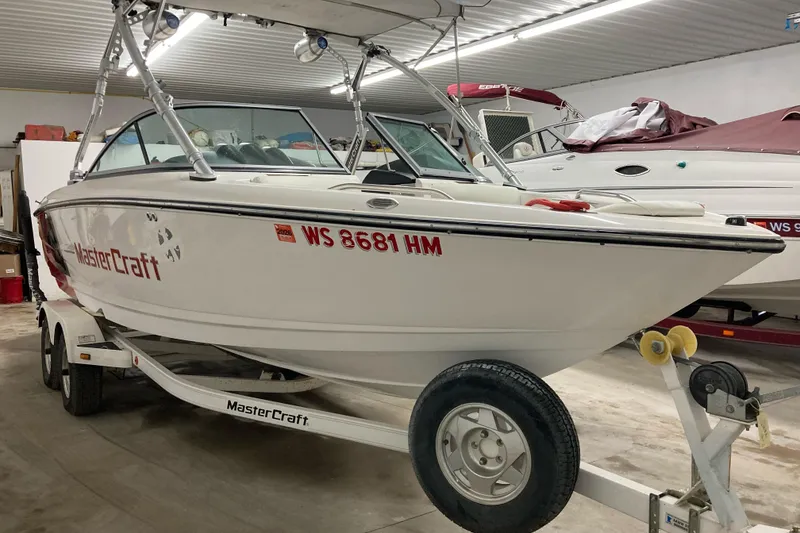 Slide: The Image of 2008 MasterCraft MariStar 215 boat on trailer in indoor storage facility. - 1
