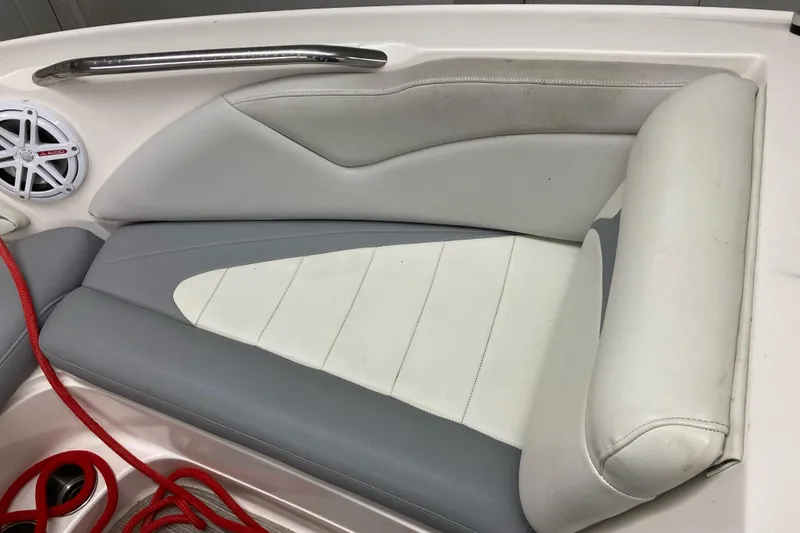 Slide: The Image of 2008 MasterCraft MariStar 215 boat interior with gray and white seating, speaker, and red rope. - 12