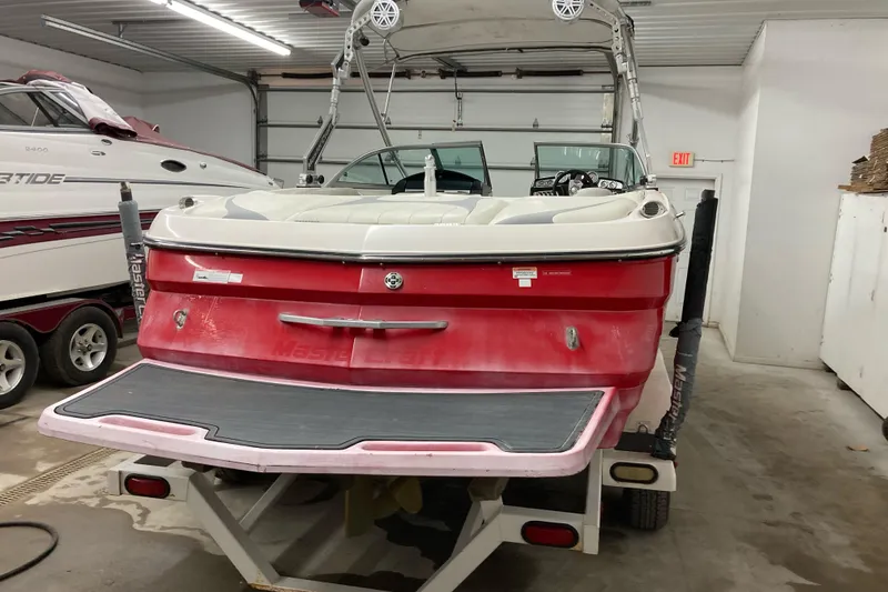 Slide: The Image of 2008 MasterCraft MariStar 215 boat in garage, rear view with swim platform. - 2