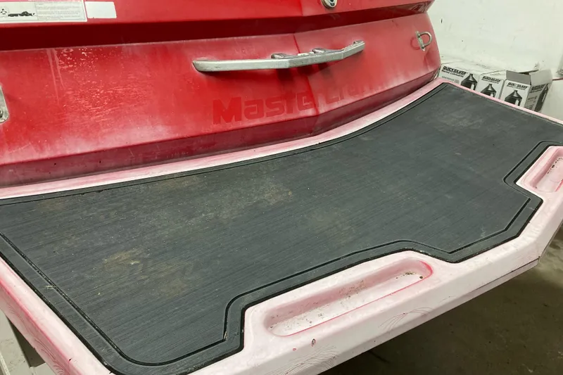 Slide: The Image of 2008 MasterCraft MariStar 215 swim platform with red detailing and black mat. - 4