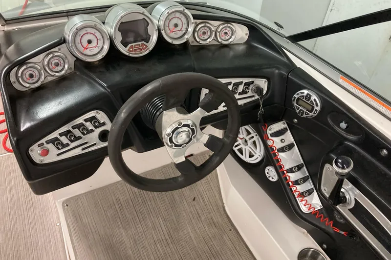 Slide: The Image of 2008 MasterCraft MariStar 215 dashboard with gauges, steering wheel, and control panel. - 7