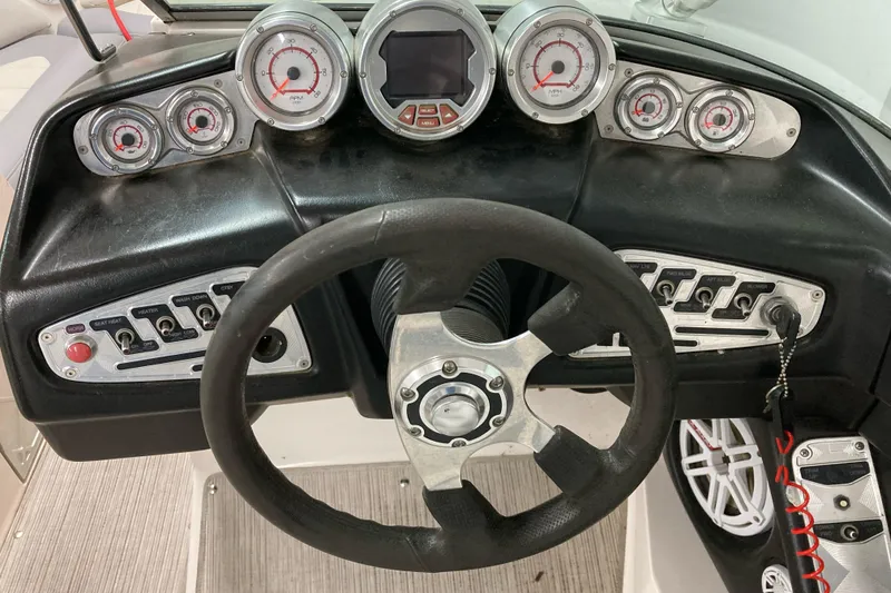 Slide: The Image of 2008 MasterCraft MariStar 215 dashboard with steering wheel and control gauges. - 8