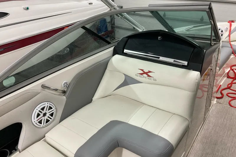 Slide: The Image of 2008 MasterCraft MariStar 215 boat interior with white seating and audio speaker. - 9
