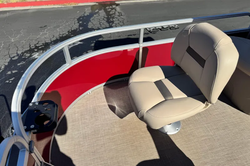 Slide: The Image of 2023 Sun Tracker Bass Buggy 16 XL boat seat with red paneling and beige upholstery. - 12