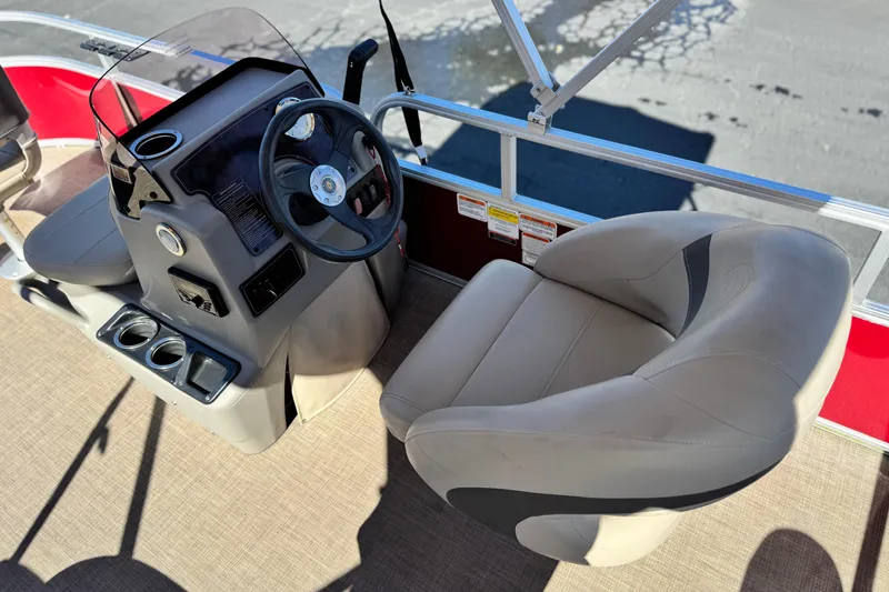 Slide: The Image of 2023 Sun Tracker Bass Buggy 16 XL boat interior with steering console and seating. - 17