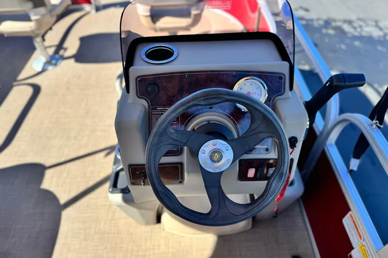 Slide: The Image of 2023 Sun Tracker Bass Buggy 16 XL steering console with gauge and cup holder. - 18