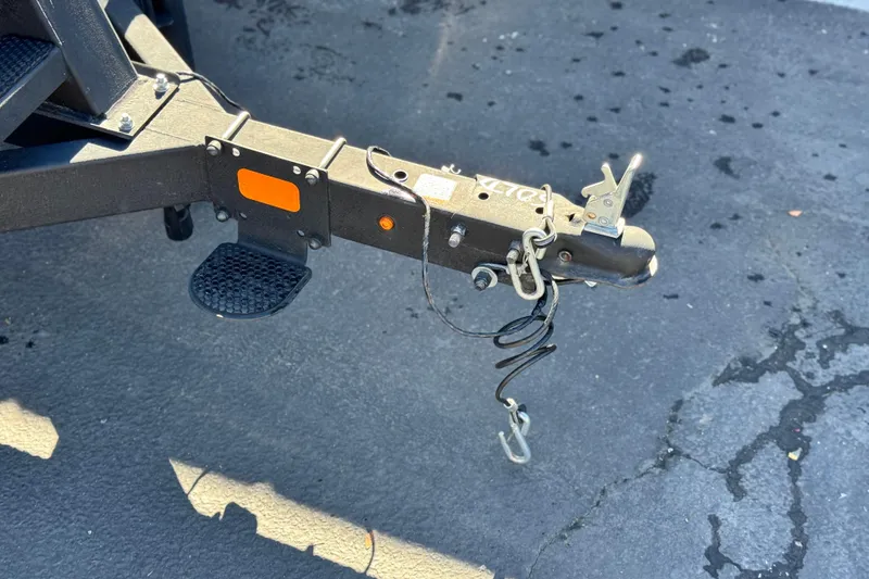 Slide: The Image of Trailer hitch of 2023 Sun Tracker Bass Buggy 16 XL on asphalt surface. - 23