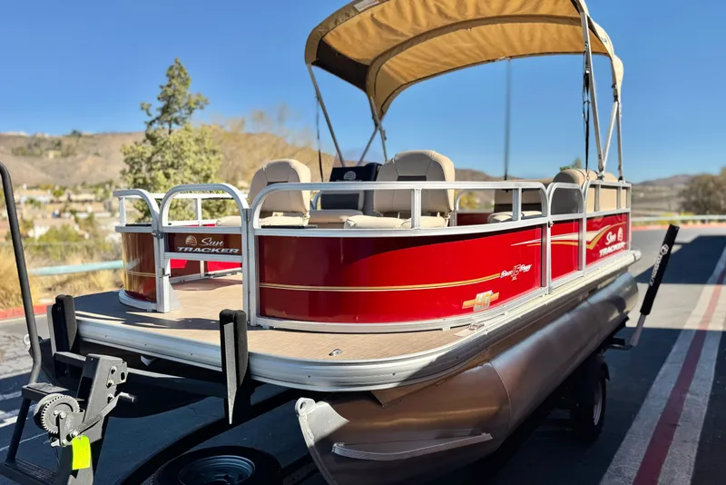 Slide: The Image of 2023 Sun Tracker Bass Buggy 16 XL pontoon boat with red exterior and canopy. - 3
