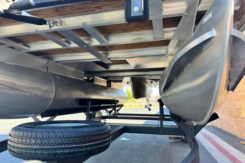 Slide: The Image of Underneath view of 2023 Sun Tracker Bass Buggy 16 XL pontoon boat on trailer. - 4