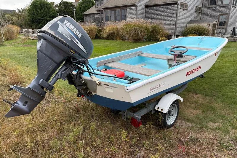 Slide: The Image of 1967 Boston Whaler 13 boat with Yamaha outboard motor on a trailer. - 4