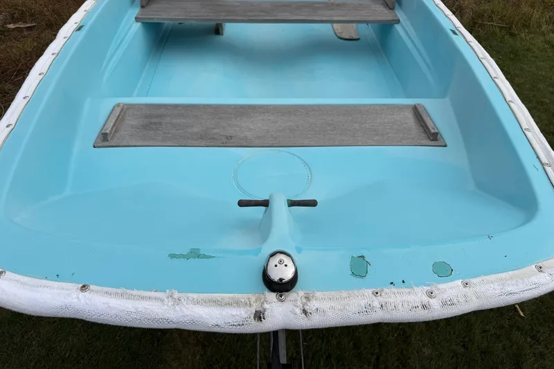 Slide: The Image of 1967 Boston Whaler 13 boat interior with light blue finish and wooden seats. - 5