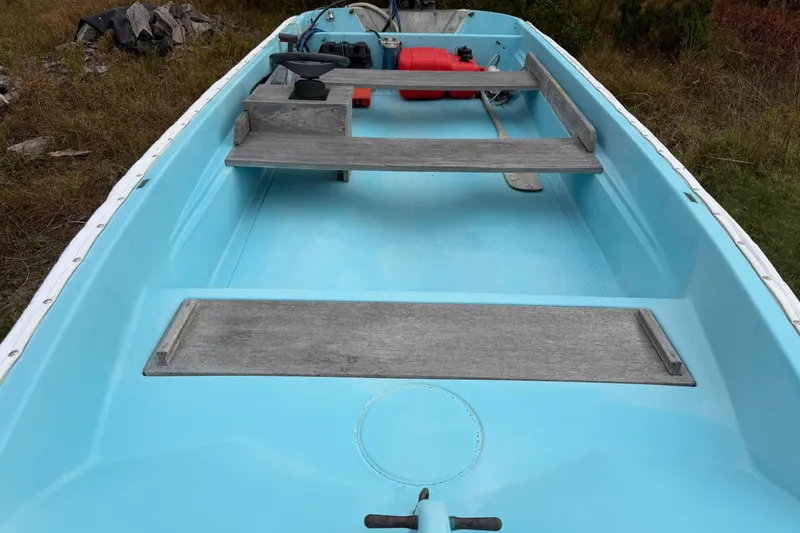 Slide: The Image of 1967 Boston Whaler 13 boat interior with blue hull and wooden seats. - 6