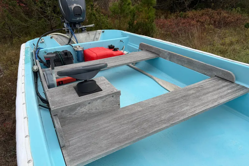 Slide: The Image of 1967 Boston Whaler 13 boat interior with wooden seats and outboard motor. - 7