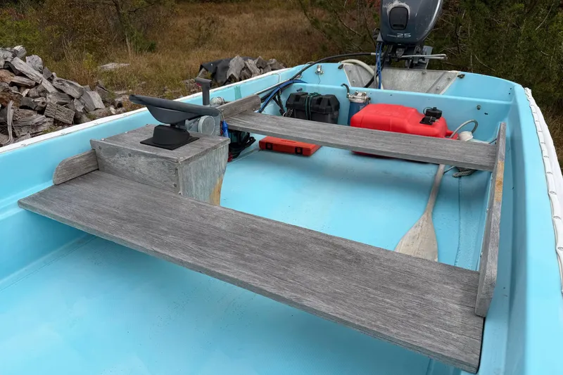 Slide: The Image of 1967 Boston Whaler 13 boat interior with wooden seats and outboard motor. - 8