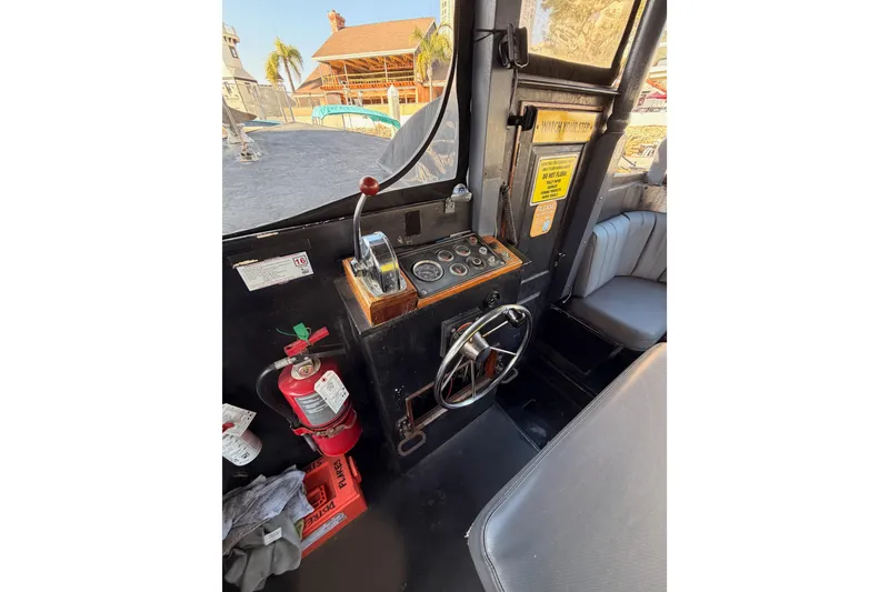 Slide: The Image of Interior of a 1983 Custom Limo Boat cockpit with steering wheel and controls. - 13