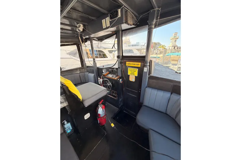 Slide: The Image of Interior of a 1983 Custom Limo Boat with seating and steering wheel. - 15