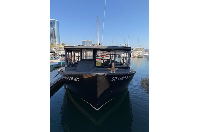 Slide: The Image of Custom 1983 Limo Boat docked in marina, surrounded by modern buildings. - 3