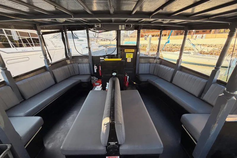 Slide: The Image of Interior of a 1983 Custom Limo Boat with spacious seating and panoramic windows. - 8