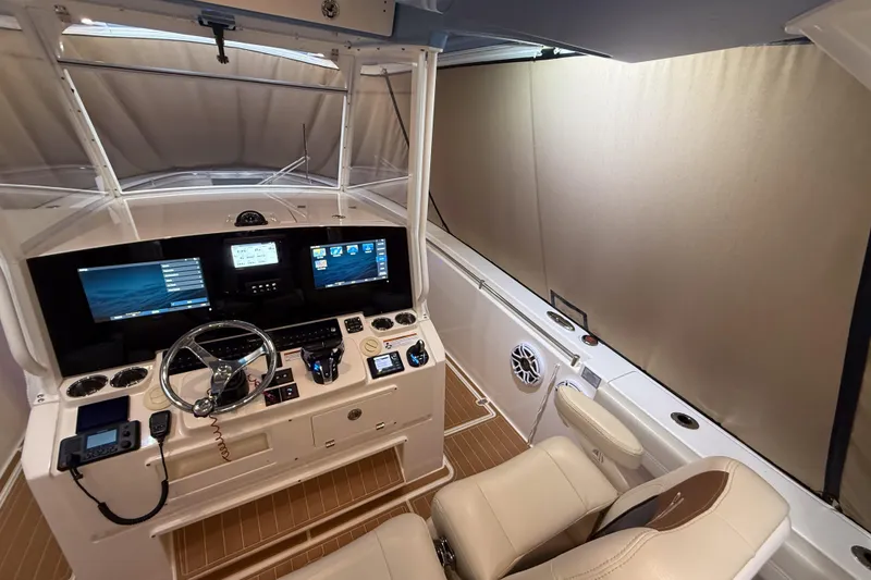 Slide: The Image of 2021 Cobia 350 CC helm with advanced navigation displays and luxurious seating. - 10