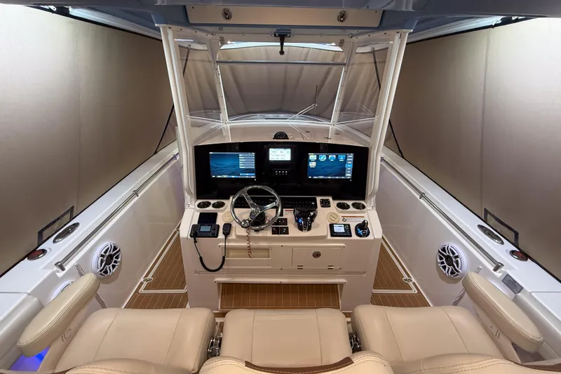 Slide: The Image of 2021 Cobia 350 CC boat cockpit with advanced navigation system and dual seating. - 11