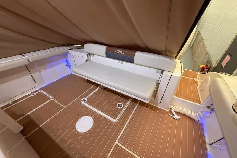 Slide: The Image of 2021 Cobia 350 CC boat interior with foldable seating and teak flooring. - 16